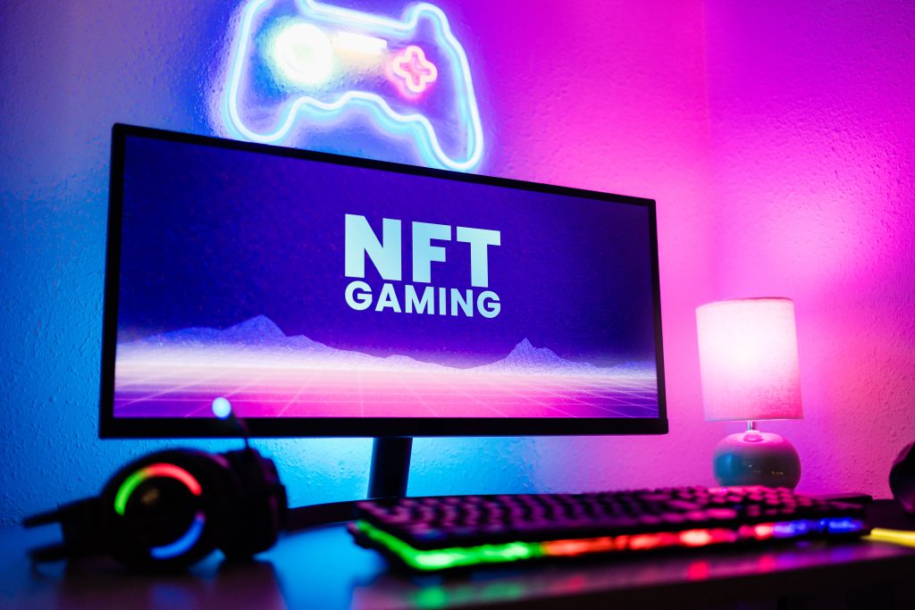 Image of a gaming setup with "NFT Gaming" written on the monitor
